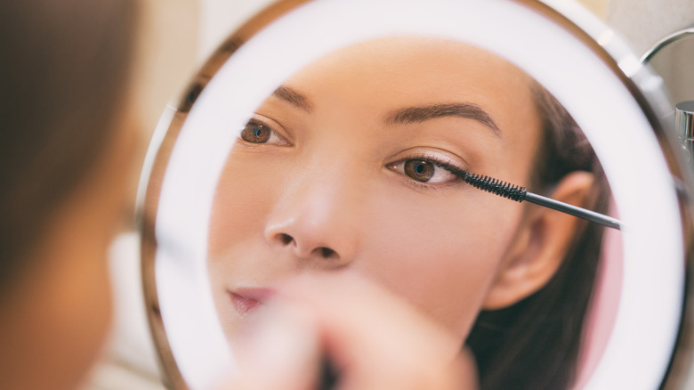 Woman applying mascara