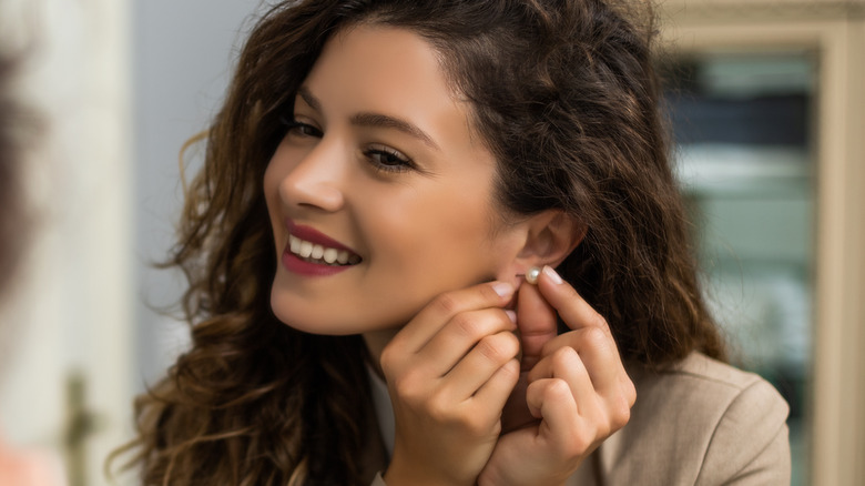 woman touching her ear 