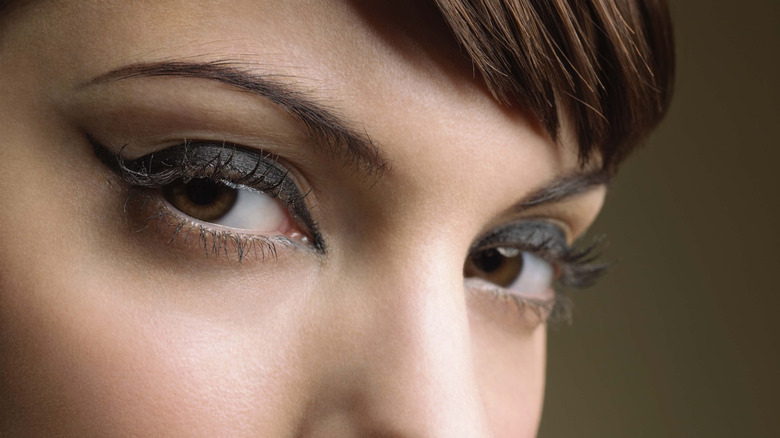 Closeup of a woman's eyes, framed by dark eyeliner, looking into the camera.