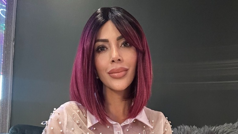Jasmine Pineda wears a black and pink wig