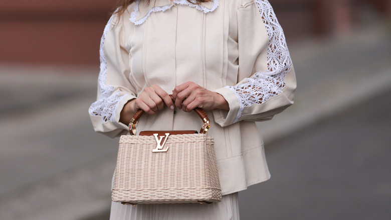 Woman carrying a top-handle bag