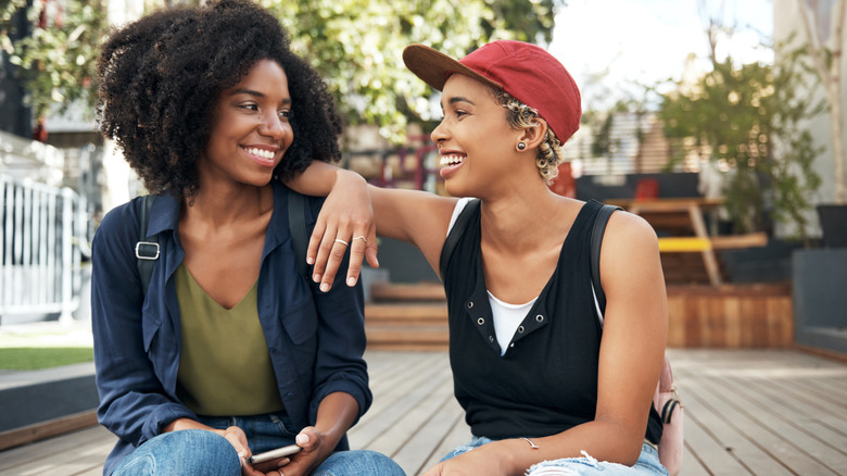 Lesbian couple on a date sitting on a patio