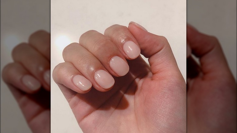 A hand with jelly pink nails