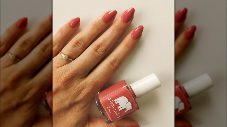 Hand holding Ella + Milla nail polish bottle