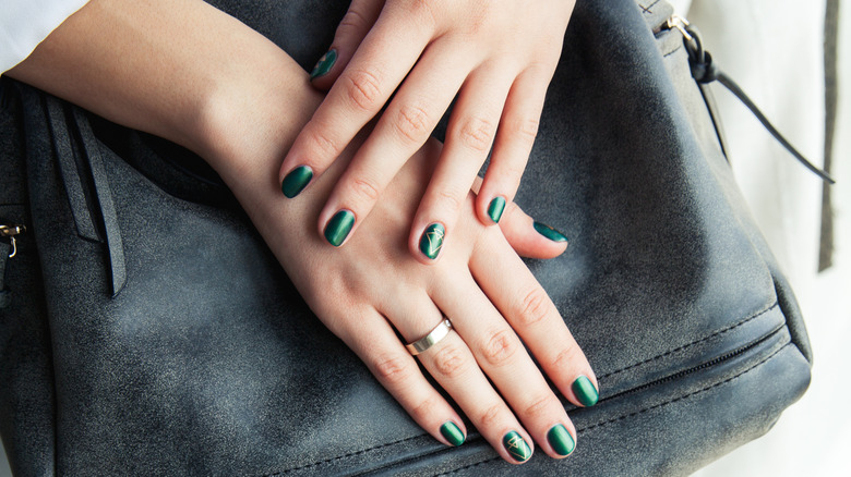 Woman with green nail polish
