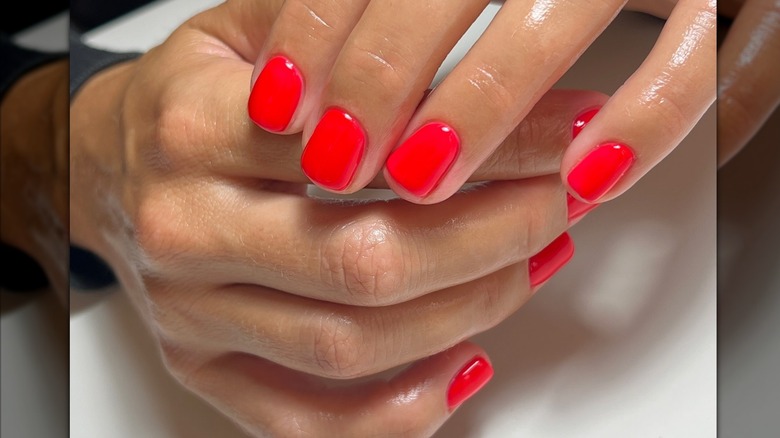 Woman with bright red nails
