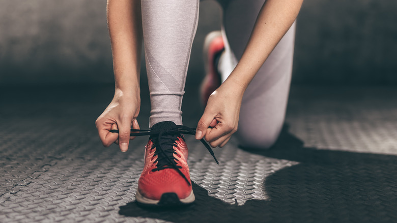 Woman tying her running shoes