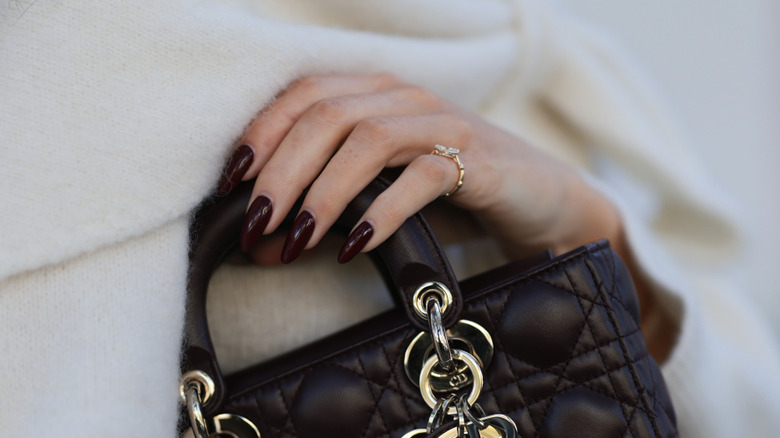 Dark, vampy nail polish on a woman's nails