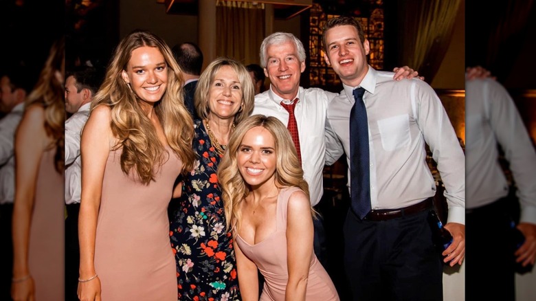 Tricia McLaughlin, her parents, and her siblings are photographed together on the dance floor