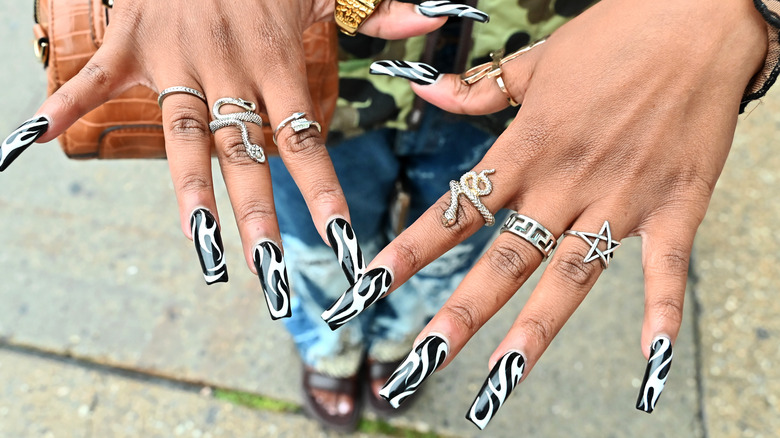 close up on white and black nails