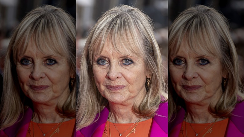 Twiggy smiles wearing bronze eyeshadow and blue eyeliner