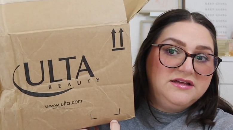YouTuber holds Ulta Beauty shipping box