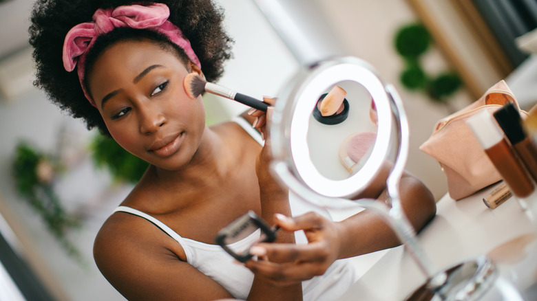 Woman applying makeup