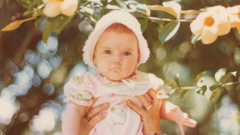 A baby being held in the air
