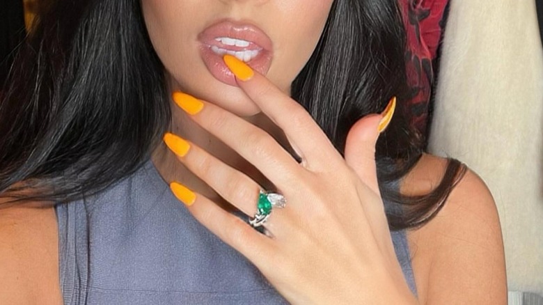 Stephen Webster Jewellery posted this selfie of Megan Fox on Instagram in 2022 with her engagement ring prominently displayed on her hand with bright orange-colored nails.