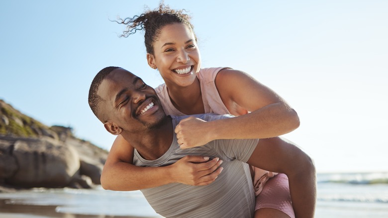 Young couple smiling at beach