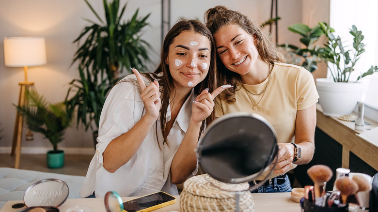 Two women doing skincare together