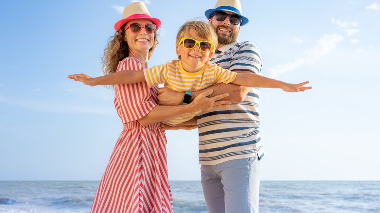 Family smiling on the beach