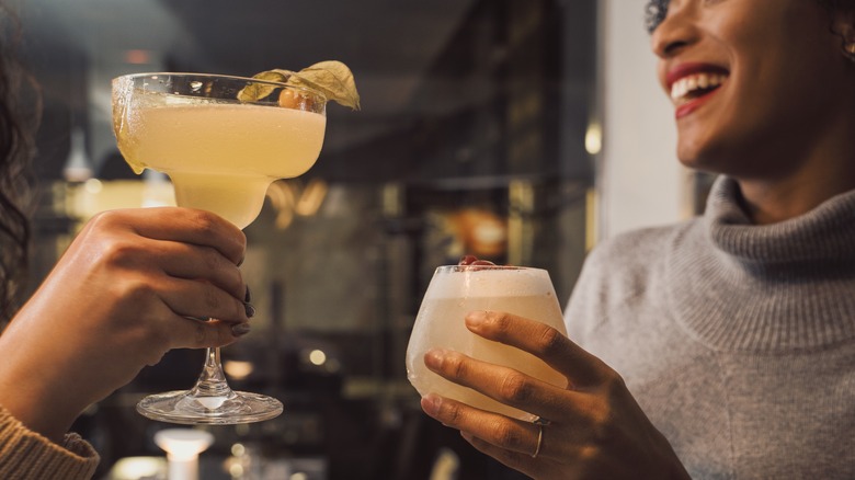 Two people with cocktails