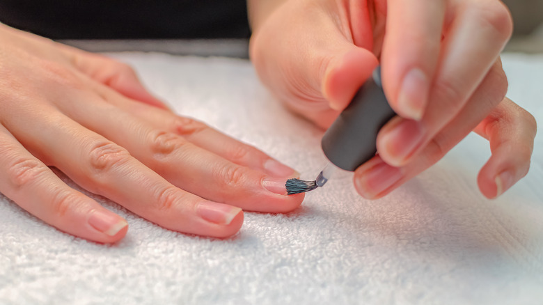 woman priming her nails