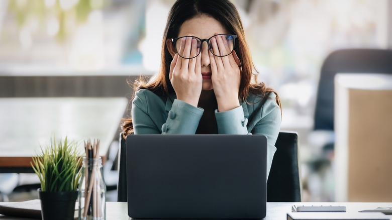 burned out woman near laptop