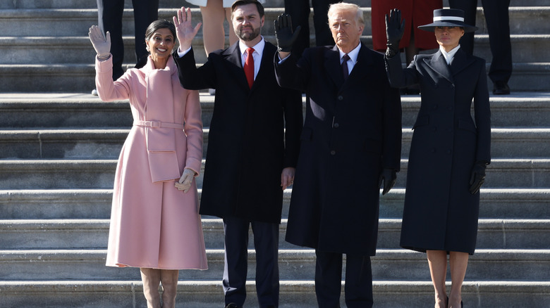Usha Vance wearing a pink coat next to JD Vance and the Trumps in black and blue
