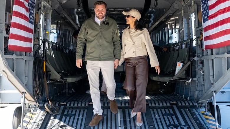 Close-up of Usha Vance. She is a middle-aged woman with brown skin and dark hair. In this image, she is smiling at someone off camera.