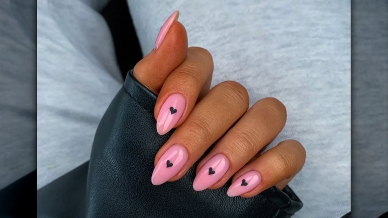 Nail art with tiny black hearts