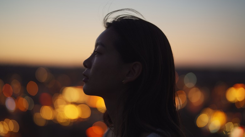 Profile of woman at night