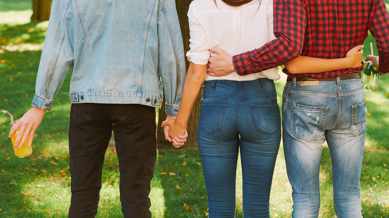 Woman standing between two men