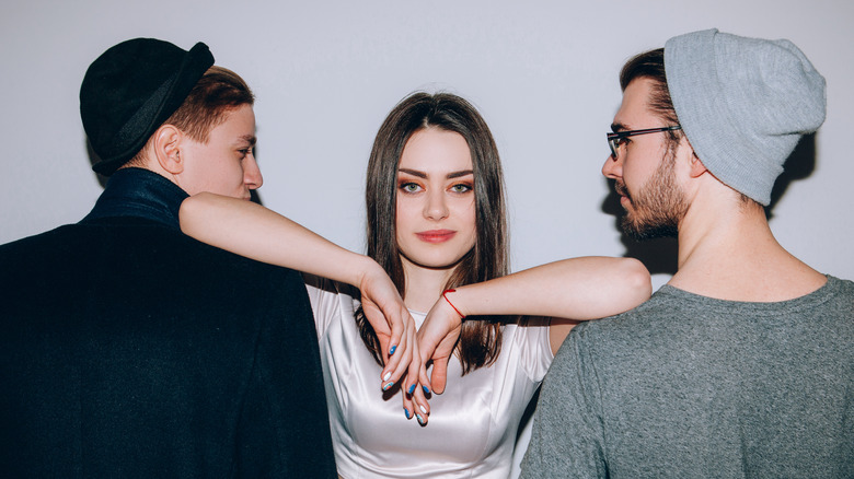 Woman standing between two men