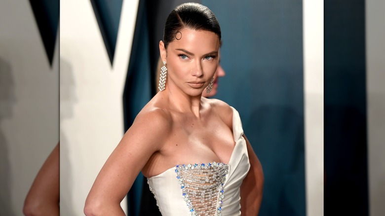 Adriana Lima wears a slicked back hairstyle and a one-shoulder gown at the Vanity Fair Oscar Party in 2020.