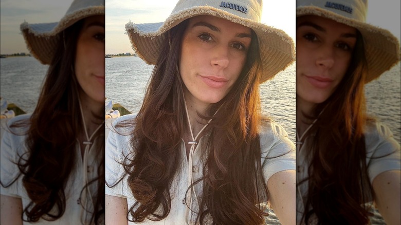 Woman with brown hair in hat