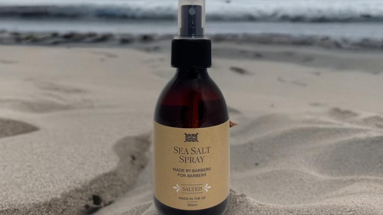 Woman using sea salt spray on hair