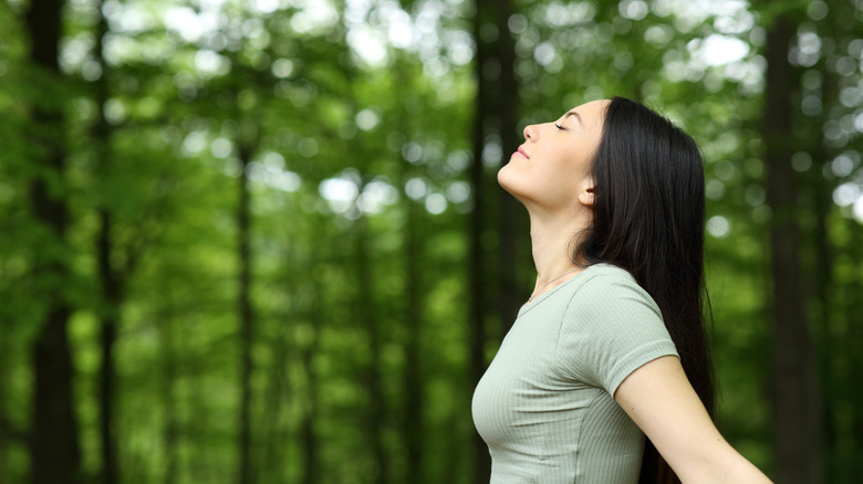 woman breathing in forest 