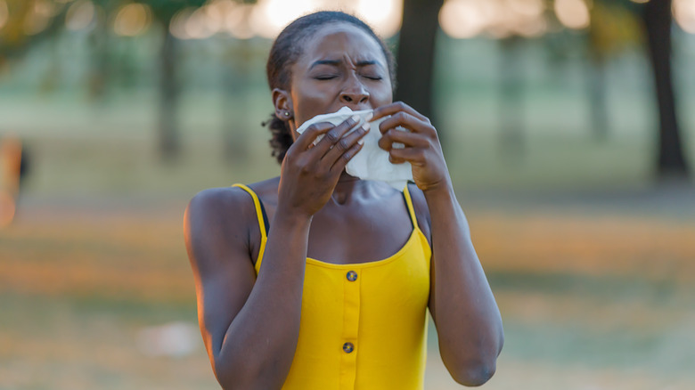 woman sneezing