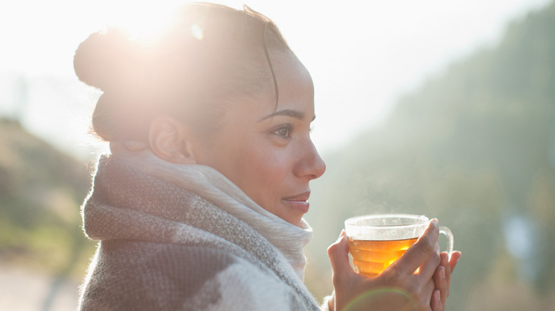 Woman smiles with tea