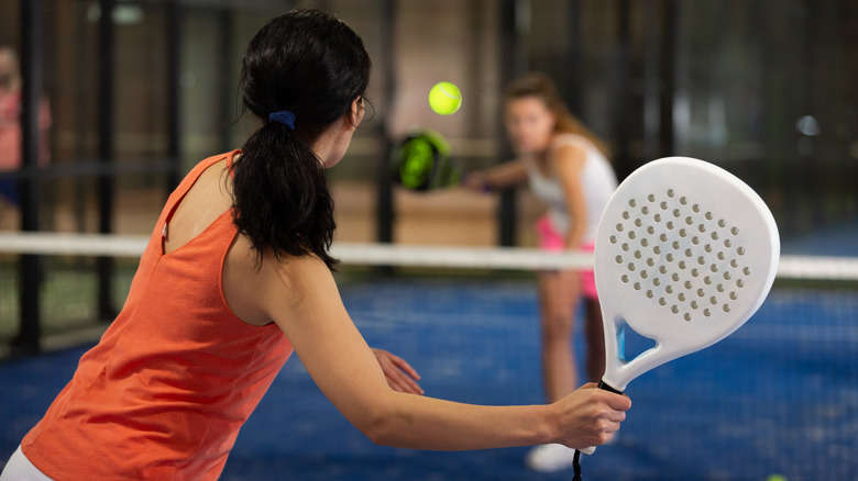 Two women playing padel