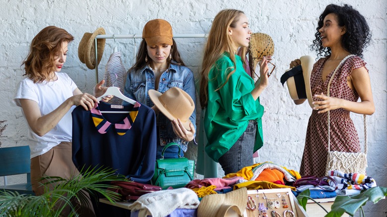 Women examining wardrobe items 