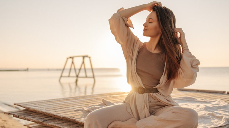 Brunette woman poses on beach 