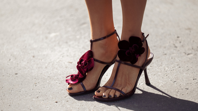 A guest wears a high heels with burgundy flowers outside Gabriela Hearst show during Day Eight of Paris Fashion Week - Womenswear Fall/Winter 2026/2027 on March 09, 2026