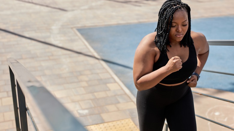 woman running up the stairs to exercise