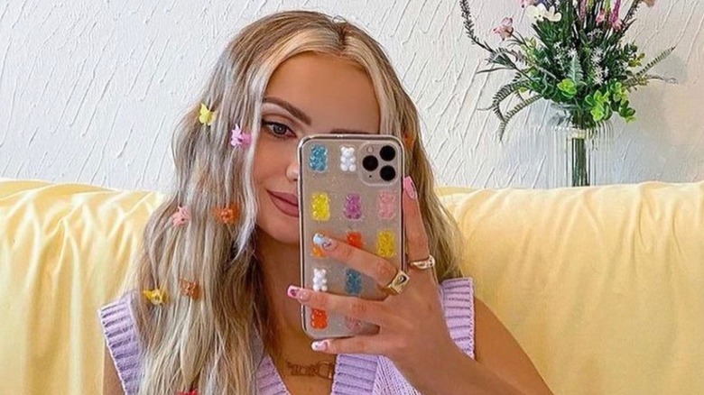 Woman with butterfly clips taking selfie