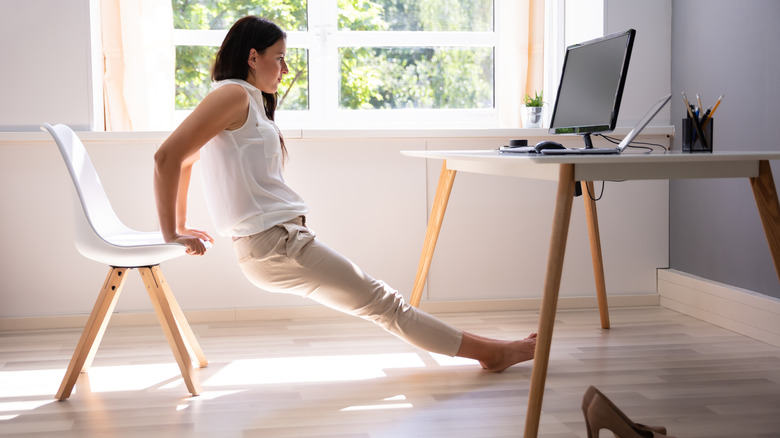 woman exercising at desk