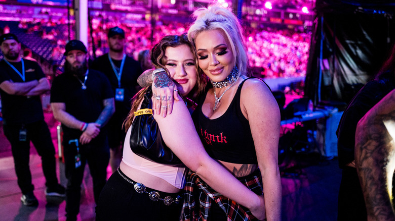 Bailee Ann DeFord and Bunnie Xo sharing a hug at a concert