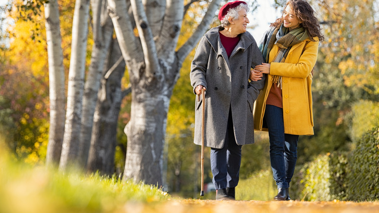 A woman and her mother walking on a path