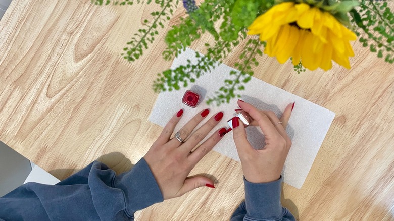 Nails being painted at table