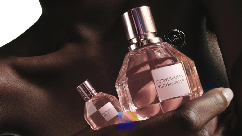 Model holding Flowerbomb perfume bottle