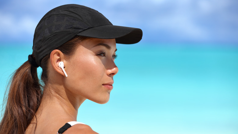 Woman wearing airpods and hat