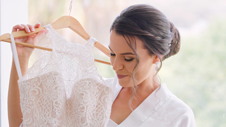 woman holding wedding dress